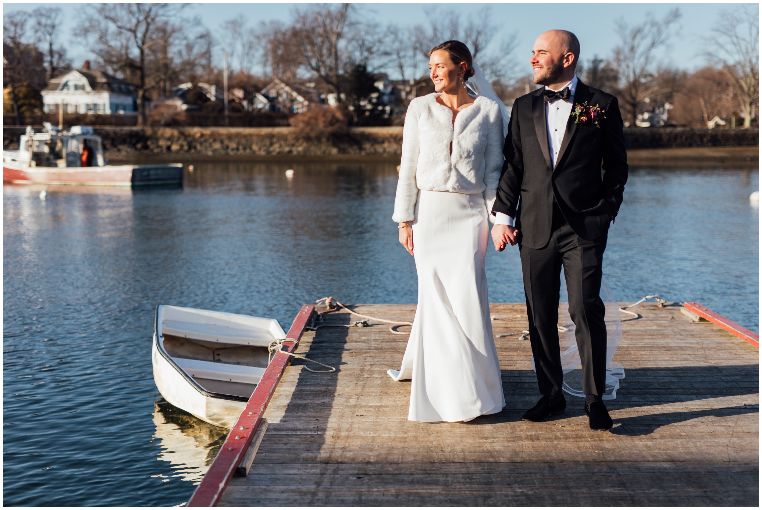 Bride and groom walking on dock during winter wedding at Red Lion Inn in Cohasset MA