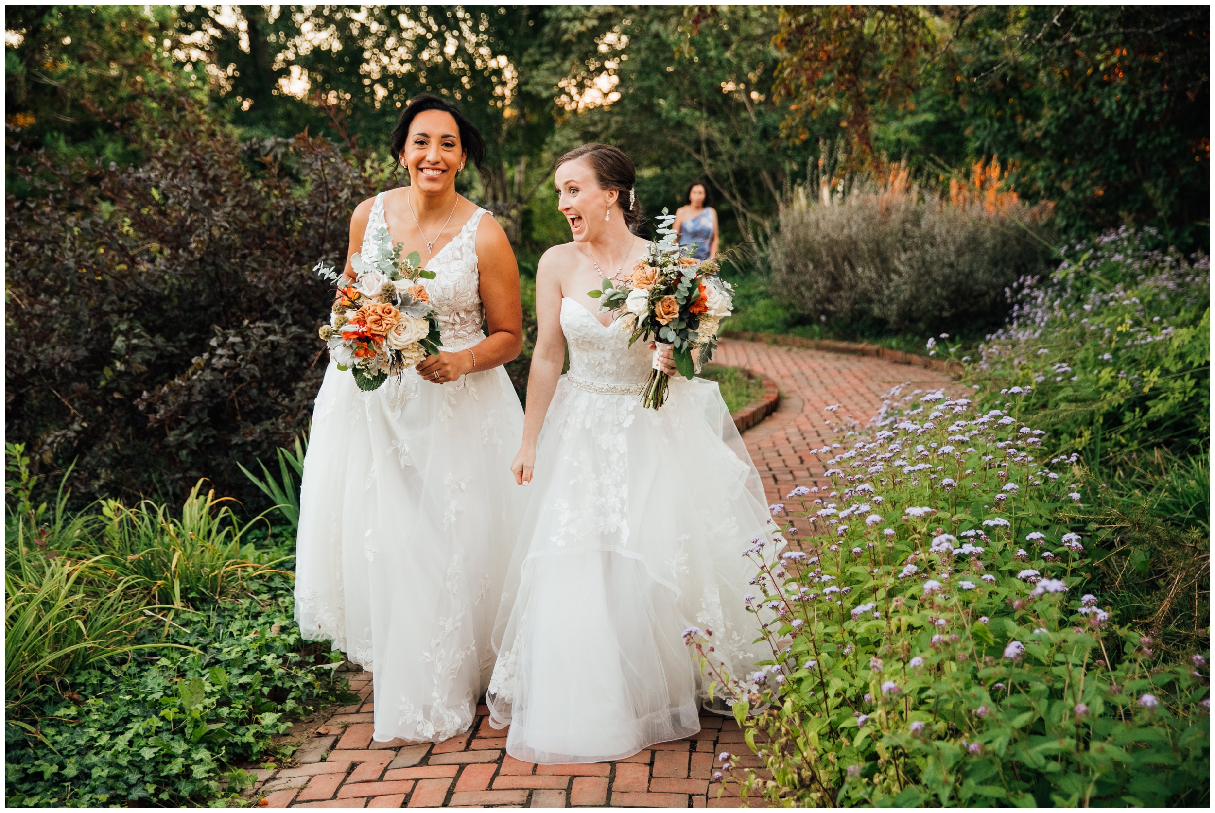 Two brides walking down the aisle after ceremony at New England Botanic Garden at Tower Hill in Massachusetts